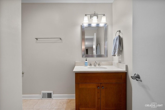 bathroom featuring baseboards, visible vents, tile patterned flooring, and vanity