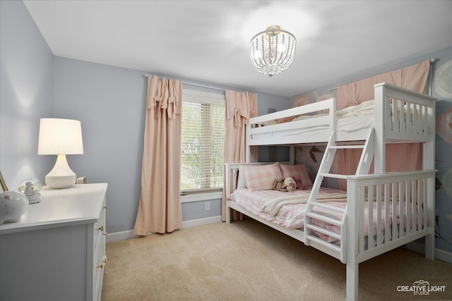 bedroom featuring baseboards, a chandelier, and light carpet