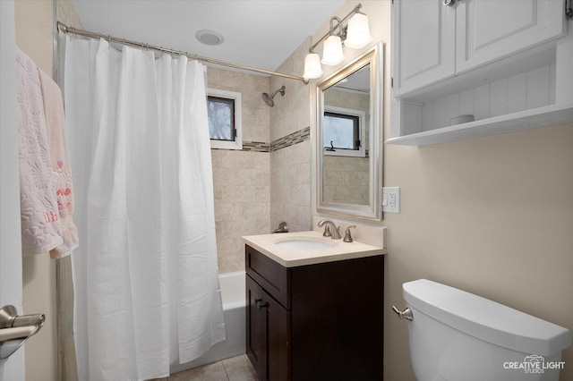 bathroom with tile patterned floors, shower / bath combo with shower curtain, vanity, and toilet