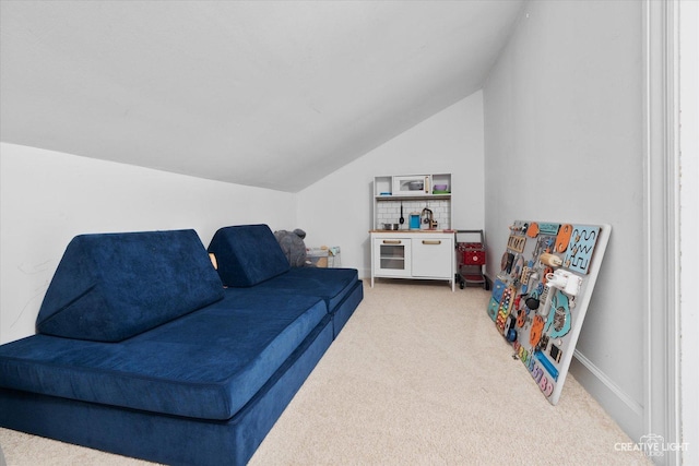 carpeted living area with vaulted ceiling