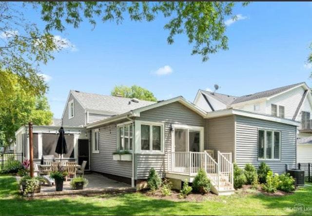 back of house with fence, a yard, a patio area, and cooling unit