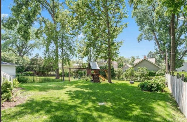 view of yard featuring a playground and a fenced backyard