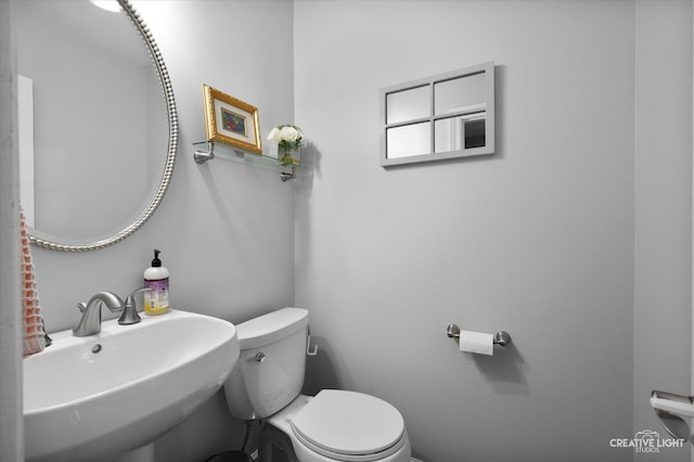 bathroom featuring a sink and toilet