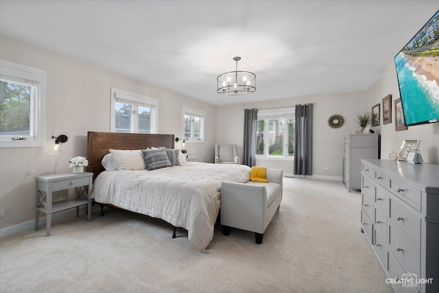 bedroom featuring baseboards, a chandelier, and light carpet