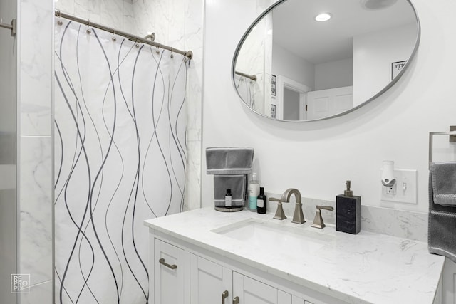 bathroom featuring vanity and curtained shower