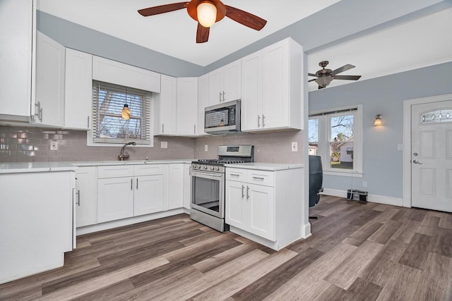 13916 S Dearborn St, Riverdale, IL 60827 - kitchen featuring light countertops, appliances with stainless steel finishes, a ceiling fan, and white cabinets