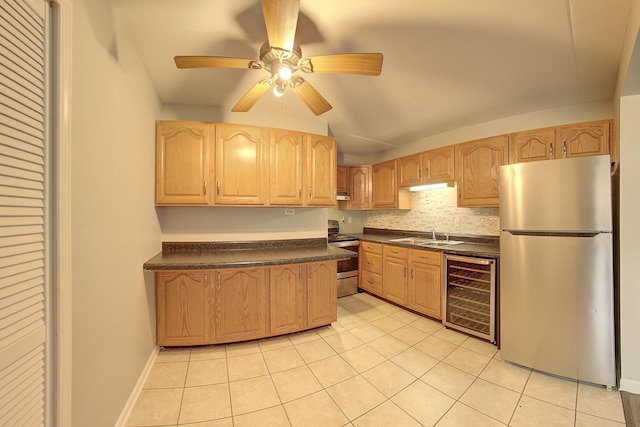 kitchen with stainless steel appliances, light brown cabinets, beverage cooler, and dark countertops