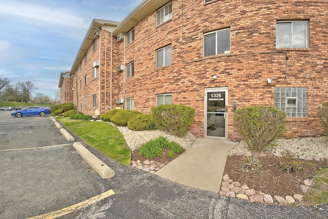 view of building exterior with uncovered parking
