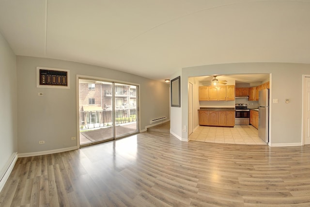 unfurnished living room with light wood finished floors, baseboard heating, and baseboards