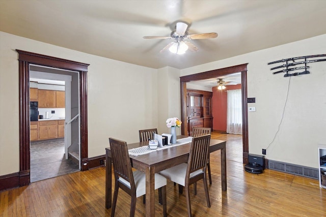 204 S Jackson Ave, Polo, IL 61064 - dining area with baseboards, visible vents, wood finished floors, and a ceiling fan