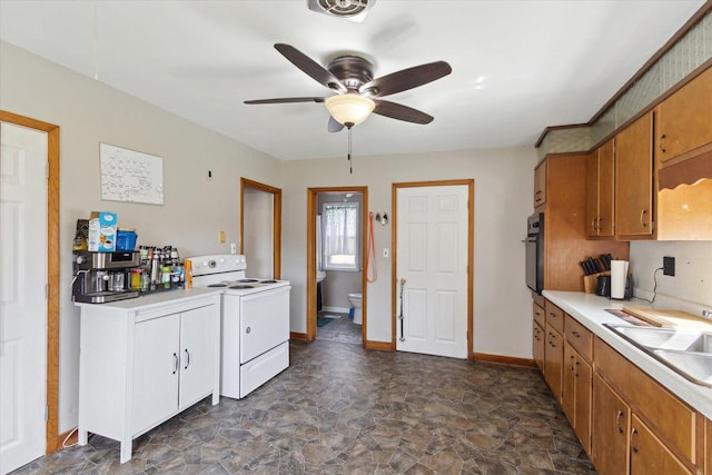 204 S Jackson Ave, Polo, IL 61064 - kitchen featuring brown cabinets, stone finish flooring, ceiling fan, light countertops, and white range with electric cooktop