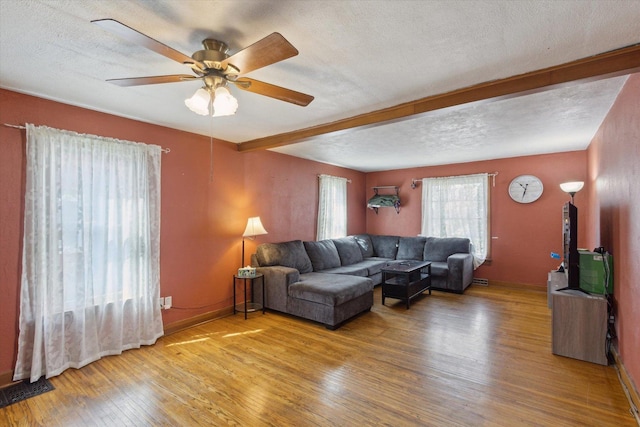 204 S Jackson Ave, Polo, IL 61064 - living area featuring beam ceiling, wood finished floors, a ceiling fan, and a textured ceiling