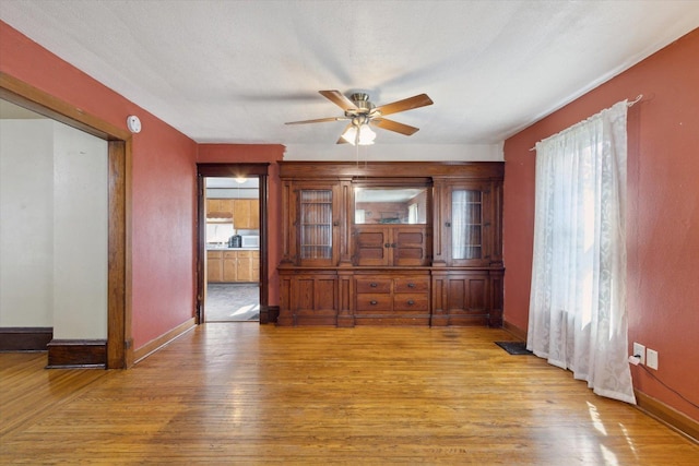 204 S Jackson Ave, Polo, IL 61064 - dining area featuring baseboards, a ceiling fan, and light wood-style flooring