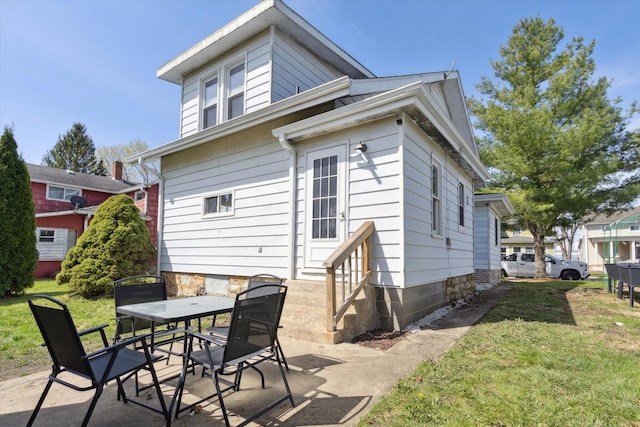 204 S Jackson Ave, Polo, IL 61064 - rear view of house with a patio, a yard, entry steps, and outdoor dining area