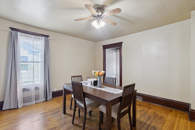 204 S Jackson Ave, Polo, IL 61064 - dining room with hardwood / wood-style floors, baseboards, visible vents, and a ceiling fan