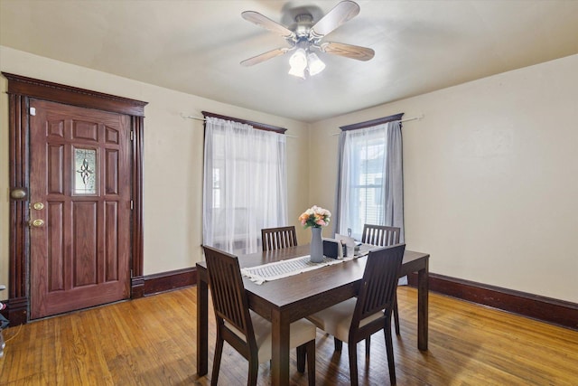 204 S Jackson Ave, Polo, IL 61064 - dining space with light wood-style floors, a ceiling fan, and baseboards