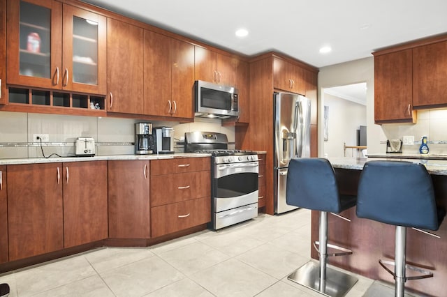 3104 Antelope Springs Rd, Northbrook, IL 60062 - kitchen with decorative backsplash, glass insert cabinets, stainless steel appliances, light tile patterned flooring, and light stone countertops