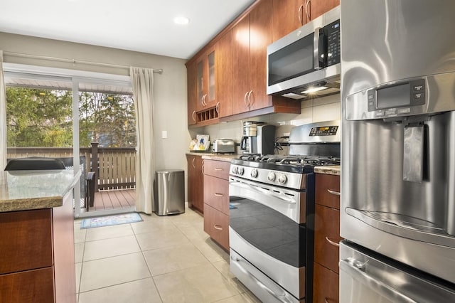3104 Antelope Springs Rd, Northbrook, IL 60062 - kitchen with light stone countertops, light tile patterned floors, glass insert cabinets, and appliances with stainless steel finishes