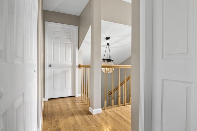 3104 Antelope Springs Rd, Northbrook, IL 60062 - hall with an upstairs landing, light wood-style flooring, and baseboards