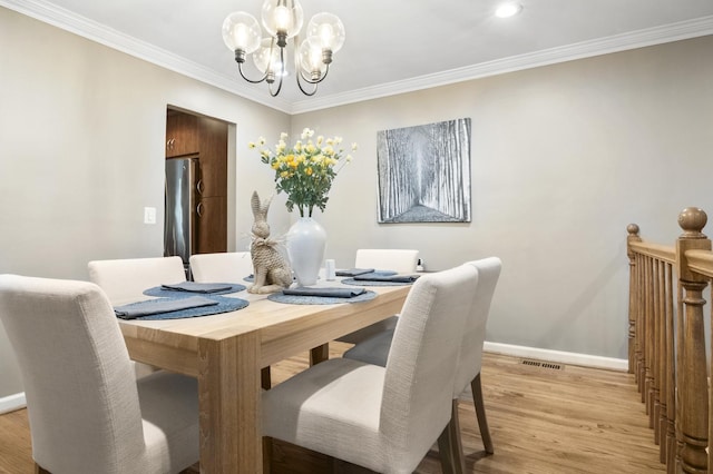 3104 Antelope Springs Rd, Northbrook, IL 60062 - dining space featuring an inviting chandelier, crown molding, light wood finished floors, and baseboards