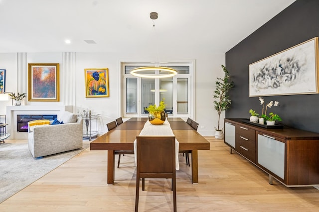1350 W Walton St Unit 1W, Chicago, IL 60642 - dining area featuring light wood finished floors and a glass covered fireplace