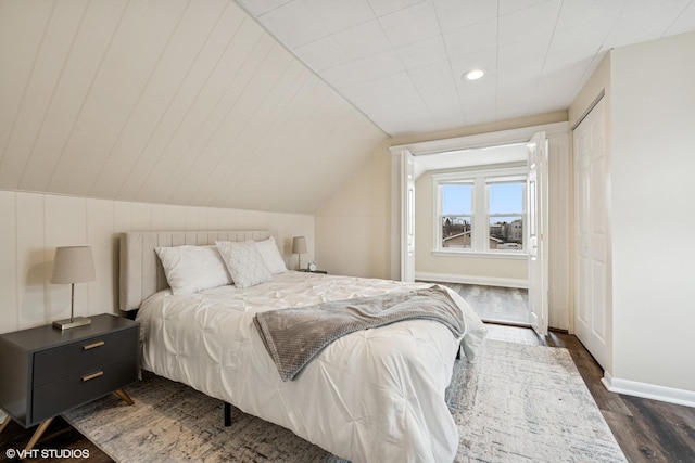 bedroom featuring baseboards, vaulted ceiling, dark wood-type flooring, and recessed lighting