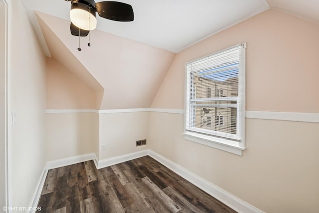 bonus room with dark wood finished floors, lofted ceiling, visible vents, and baseboards