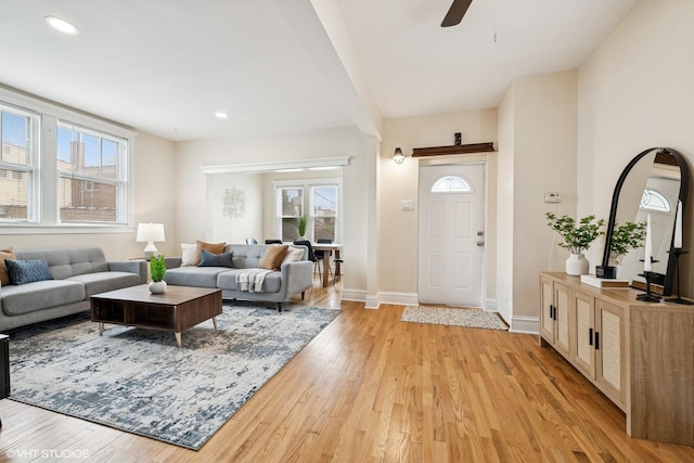 living room featuring recessed lighting, light wood-style flooring, baseboards, and ceiling fan