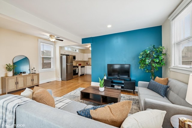 living area with recessed lighting, light wood-type flooring, baseboards, and ceiling fan