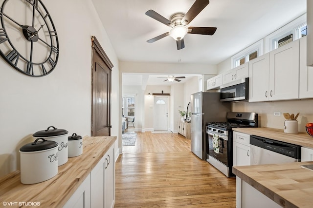 kitchen with butcher block countertops, ceiling fan, light wood-type flooring, and stainless steel appliances