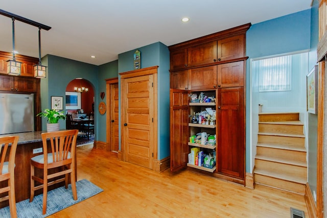 605 Ashland Ave, River Forest, IL 60305 - interior space with arched walkways, pendant lighting, light wood-style flooring, visible vents, and freestanding refrigerator