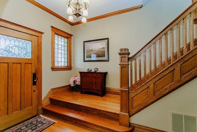 605 Ashland Ave, River Forest, IL 60305 - entrance foyer featuring wood finished floors, an inviting chandelier, stairs, visible vents, and crown molding