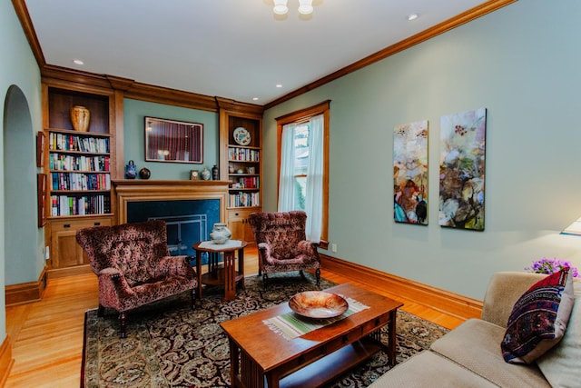 605 Ashland Ave, River Forest, IL 60305 - living area with light wood-style flooring, baseboards, built in shelves, crown molding, and a fireplace