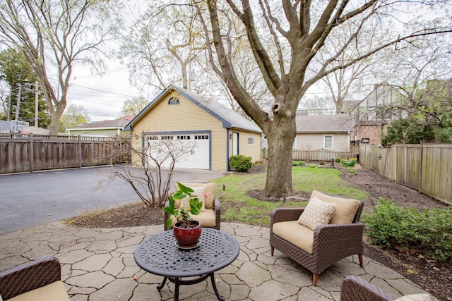 605 Ashland Ave, River Forest, IL 60305 - view of patio / terrace with a detached garage, a fenced backyard, and an outbuilding