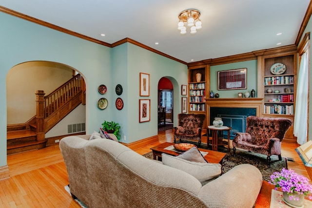 605 Ashland Ave, River Forest, IL 60305 - living room featuring arched walkways, visible vents, stairs, ornamental molding, and wood-type flooring