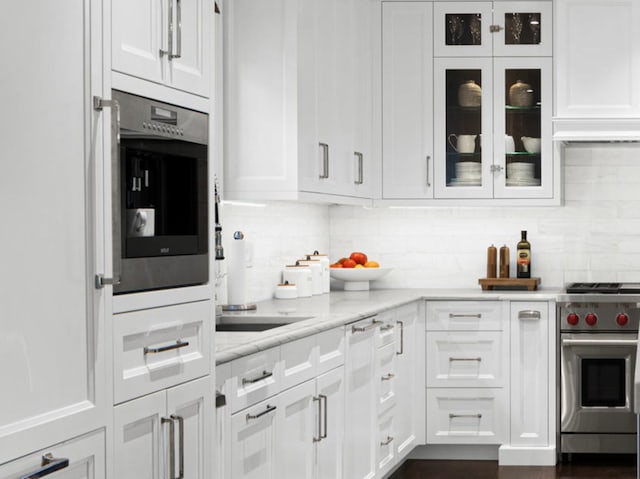 301 Canterbury Ln, Inverness, IL 60010 - kitchen with appliances with stainless steel finishes, white cabinetry, glass insert cabinets, and decorative backsplash