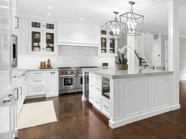 301 Canterbury Ln, Inverness, IL 60010 - kitchen featuring double oven range, white cabinetry, tasteful backsplash, light stone counters, and recessed lighting