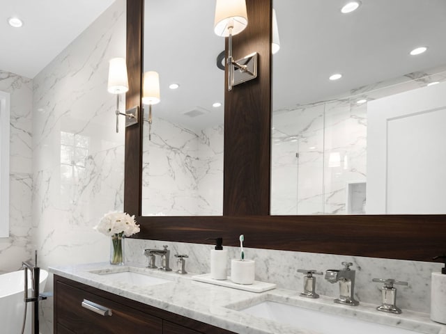 301 Canterbury Ln, Inverness, IL 60010 - full bath featuring recessed lighting, double vanity, a soaking tub, and stone wall