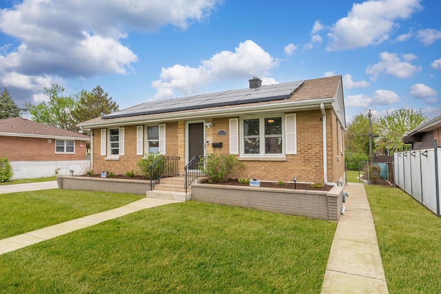 1213 N Irving Ave, Berkeley, IL 60163 - view of front of property with a front lawn, brick siding, solar panels, and fence