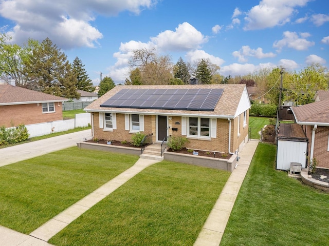 1213 N Irving Ave, Berkeley, IL 60163 - view of front of home featuring brick siding, a shingled roof, concrete driveway, a front yard, and roof mounted solar panels