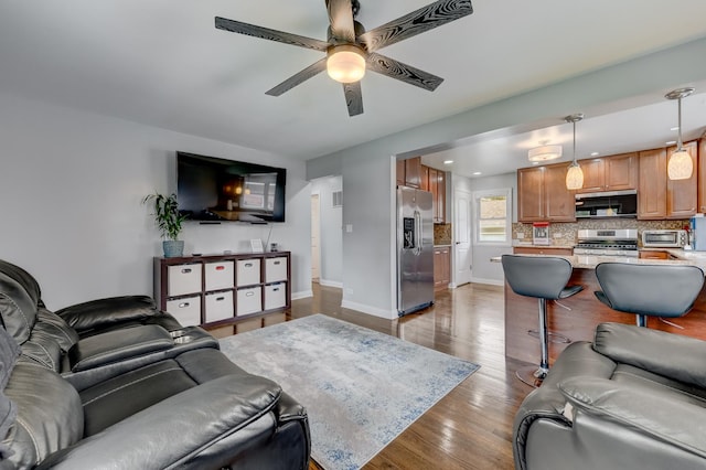 1213 N Irving Ave, Berkeley, IL 60163 - living room with ceiling fan, baseboards, a toaster, and wood finished floors