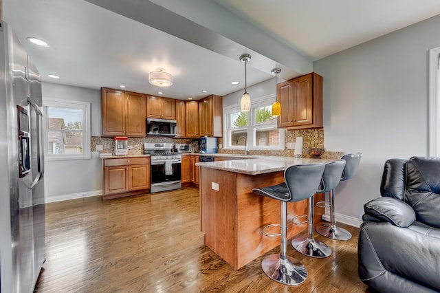 1213 N Irving Ave, Berkeley, IL 60163 - kitchen featuring a peninsula, open floor plan, baseboards, and appliances with stainless steel finishes