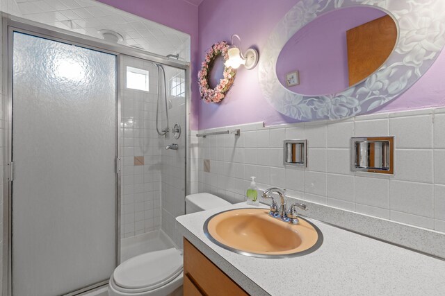 4620 Grace St, Schiller Park, IL 60176 - full bathroom featuring a shower stall, toilet, vanity, and tile walls