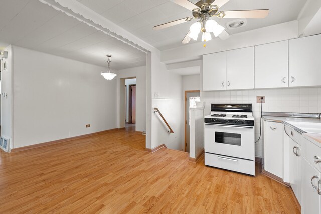 4620 Grace St, Schiller Park, IL 60176 - kitchen with ceiling fan, light wood-style flooring, backsplash, white cabinetry, and gas range gas stove