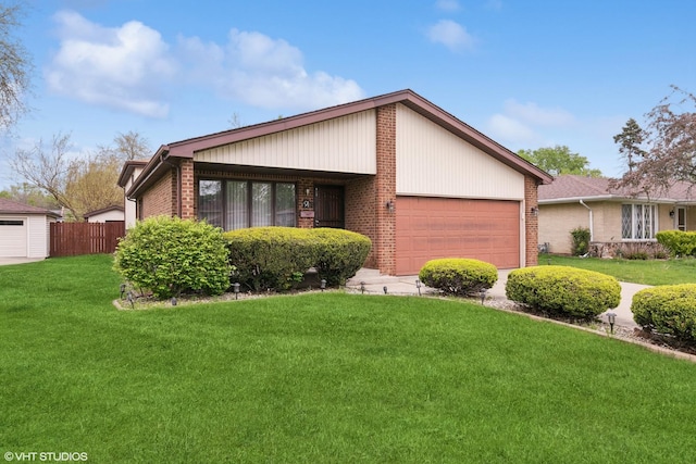 91 Frances Ln, Chicago Heights, IL 60411 - view of front facade with brick siding, fence, a front yard, and a garage
