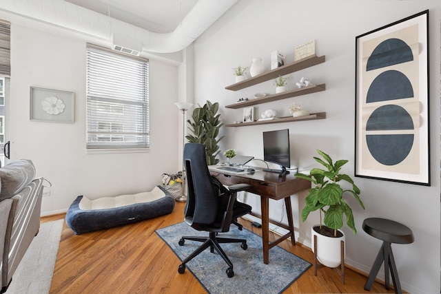 office space featuring baseboards and wood finished floors