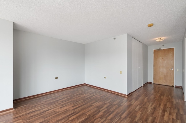 1122 N Clark St Unit 1702, Chicago, IL 60610 - empty room with dark wood-style flooring, baseboards, a textured ceiling, and a smoke detector