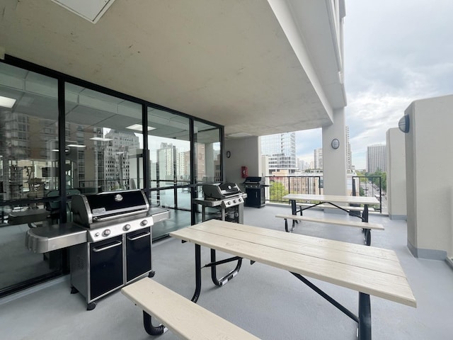 1122 N Clark St Unit 1702, Chicago, IL 60610 - view of patio featuring a city view, a grill, and a balcony