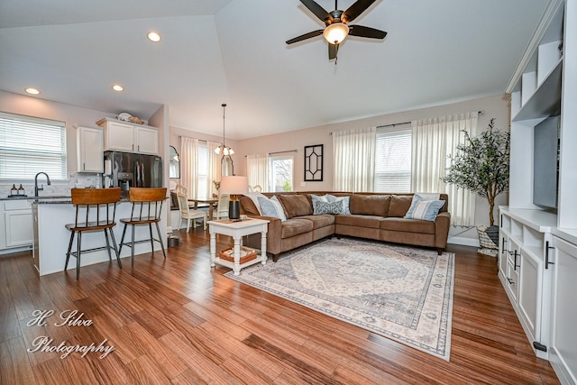 730 Goodfield Lndg, Elgin, IL 60124 - living area with dark wood-type flooring, plenty of natural light, lofted ceiling, and ceiling fan with notable chandelier