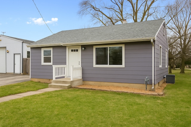 bungalow-style home featuring a front lawn, a chimney, a shingled roof, and a garage